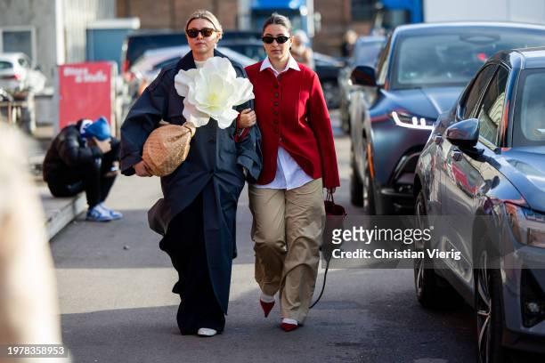 Elise Bak wears navy coat with appliquéd flower brown Bottega Veneta bag & Benthe Liem wears red jacket, beige pants, white button shirt, red rose...