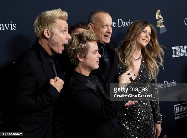 Rita Wilson and Tom Hanks pose with Green Day on the red carpet of the 66th Grammy Awards Pre-Grammy Gala at the Beverly Hilton on February 3, 2024...