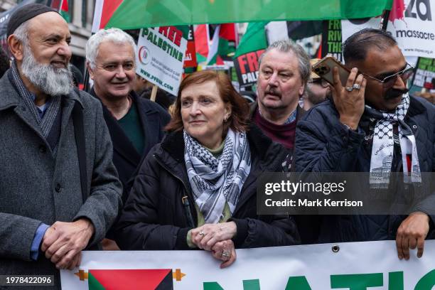 Ismail Patel, Andrew Murray, Emma Dent Coad and Ammar Anwar stand behind a banner before a march by tens of thousands of pro-Palestinian protesters...