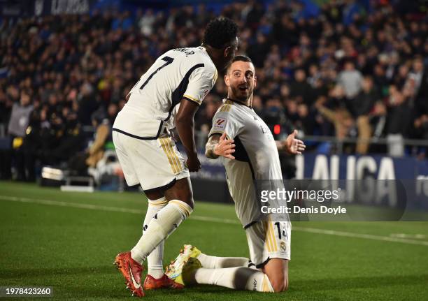Joselu of Real Madrid celebrates scoring his team's second goal with teammate Vinicius Junior during the LaLiga EA Sports match between Getafe CF and...