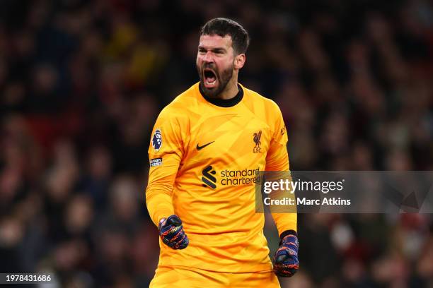 Alisson Becker of Liverpool celebrates the equalising goal during the Premier League match between Arsenal FC and Liverpool FC at Emirates Stadium on...