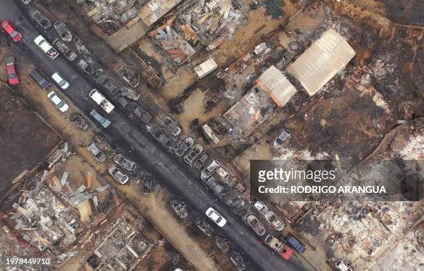 Aerial view of burned homes and vehicles after a forest fire in Quilpue, Viña del Mar, Chile, taken on February 4, 2024. Chileans Sunday feared a...