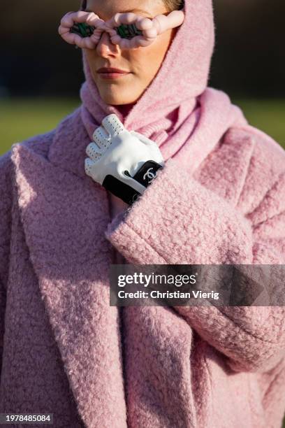 Guest wears pink coat, scarf, jumper, sunglasses, Chanel gloves outside Marimekko during the Copenhagen Fashion Week AW24 on February 01, 2024 in...