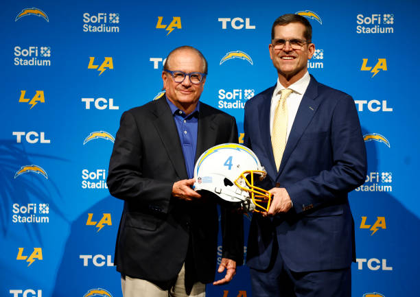 Owner and Chairman of the Board Dean Spanos and Newly appointed head coach Jim Harbaugh of the Los Angeles Chargers pose during a press conference at...