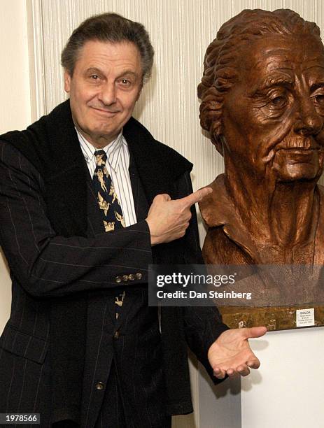 Director Joe Bologna points at a bust of Golda Meir as he arrives at the opening night of the play "An Evening With Golda Meir" at The Canon Theatre...