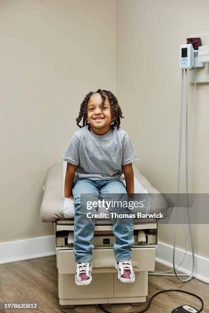 wide shot portrait patient in medical exam room during doctor visit - examination table stock pictures, royalty-free photos & images