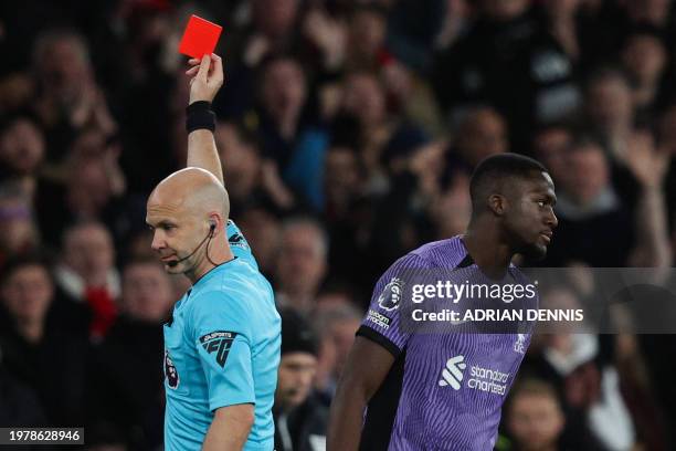 Referee Anthony Taylor shows a red card to Liverpool's French defender Ibrahima Konate during the English Premier League football match between...