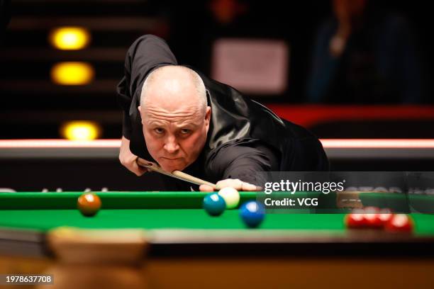 John Higgins of Scotland plays a shot in the fourth round match against Mark Allen of Northern Ireland on day four of 2024 BetVictor German Masters...