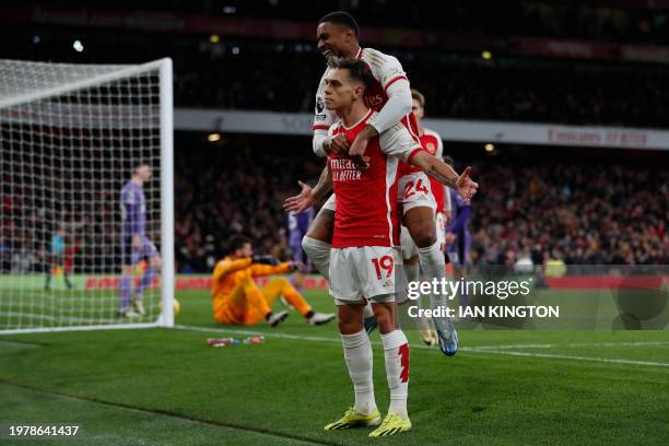 Arsenal's Belgian midfielder Leandro Trossard celebrates with teammates after scoring his team third goal during the English Premier League football...