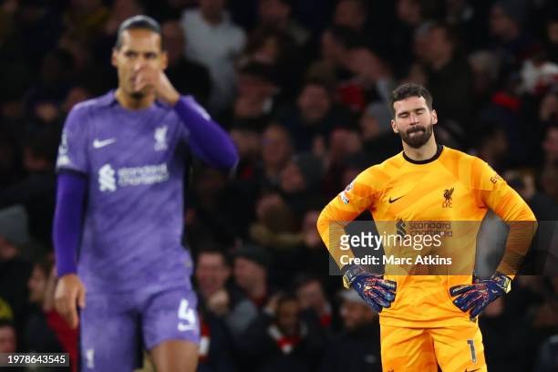 Alisson Becker and Virgil van Dijk of Liverpool react after Arsenal score the second goal during the Premier League match between Arsenal FC and...