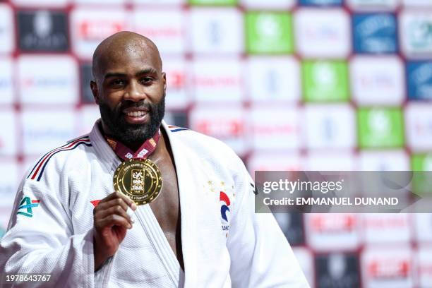 France's Teddy Riner poses with his gold medal on the podium of the men's +100kg during the Paris Grand Slam judo tournament in Paris on February 4,...