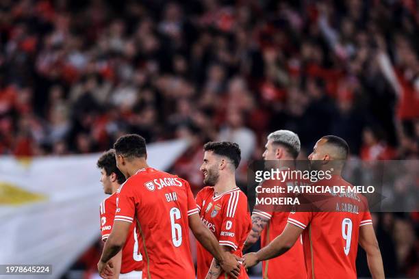 Benfica's Portuguese midfielder Rafa Silva celebrates with teammates after scoring his team's third goal during the Portuguese League football match...