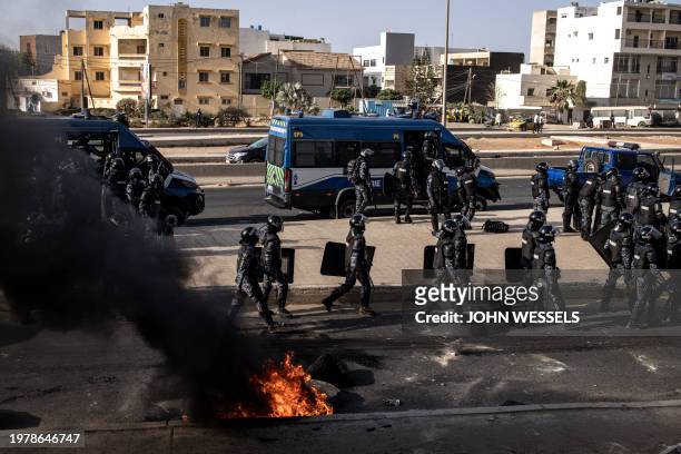 Senegalese gendarmes patrol a road during demonstrations called by the opposition parties in Dakar on February 4 to protest against postponement of...