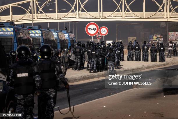 Senegalese gendarmes stand guard during demonstrations called by the opposition parties in Dakar on February 4 to protest against postponement of the...