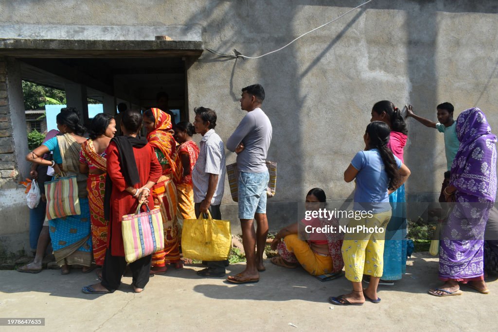 India Ration Line People are standing in line to receive their rations at a temporary ...