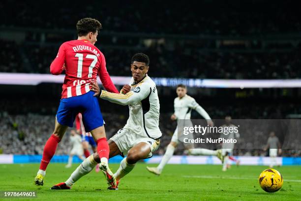 Jude Bellingham central midfield of Real Madrid and England and Rodrigo Riquelme left winger of Atletico de Madrid and Spain compete for the ball...