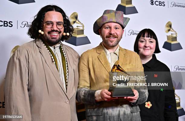 Annie Collinge with Luke Brooks and James Theseus Buck of Rottingdean Bazaar pose in the press room with the Grammy for Best Recording Package for...