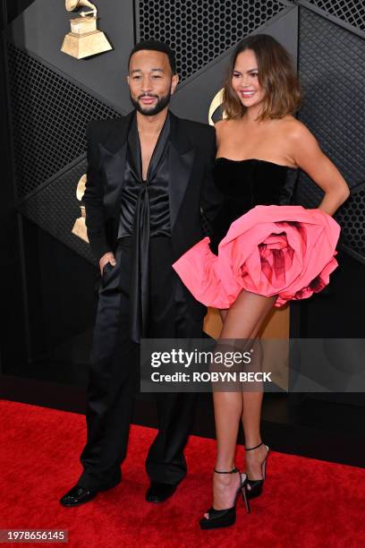 Chrissy Teigen and US singer-songwriter John Legend arrive for the 66th Annual Grammy Awards at the Crypto.com Arena in Los Angeles on February 4,...