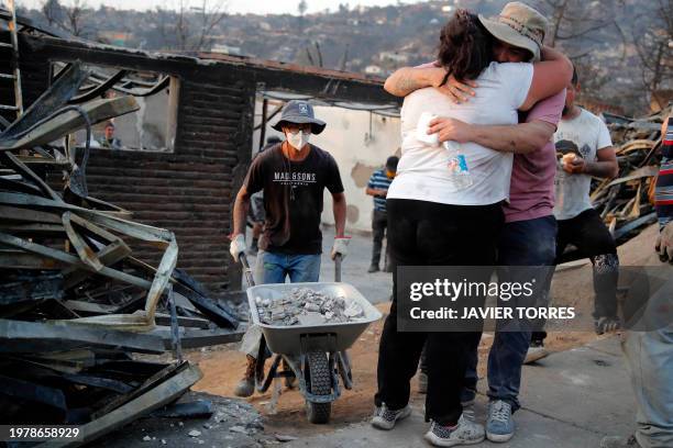 Couple hug after a wildfire in Villa Independencia, Valparaiso region, Chile on February 4, 2024. The death toll from the forest fires in Chile rose...