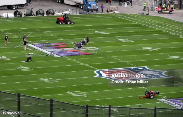 Workers paint a Super Bowl LVIII logo on the field outside of Allegiant Stadium on February 01, 2024 in Las Vegas, Nevada. The game will be played on...