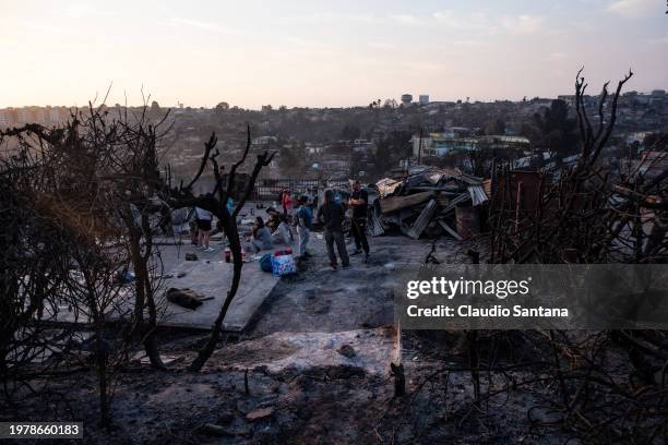 Group of volunteers gather to clean up rubble from destroyed houses at El Olivar neighborhood on February 4, 2024 in Vina del Mar, Chile. President...