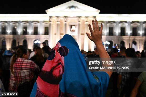 Supporters of Salvadoran President Nayib Bukele gather outside the National Palace to celebrate his re-election during the presidential and...