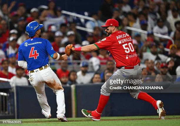 Mexico's infielder Agustin Murillo Pineda tags out Dominican infielder Gustavo Nunez at third base during the Caribbean Series baseball game between...