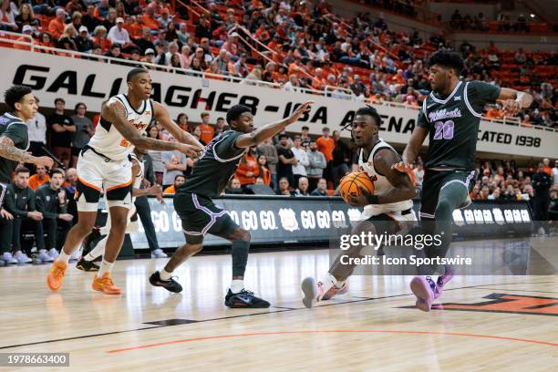 Oklahoma State Cowboys guard Quion Williams drives around Kansas State Wildcats forward Jerrell Colbert on February 3rd, 2024 at Gallagher-Iba Arena...