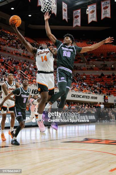 Oklahoma State Cowboys guard Jamyron Keller shoots the ball around Kansas State Wildcats forward Jerrell Colbert on February 3rd, 2024 at...