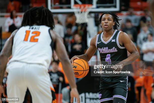 Kansas State Wildcats guard Dai Dai Ames brings the ball up court around Oklahoma State Cowboys guard Javon Small on February 3rd, 2024 at...