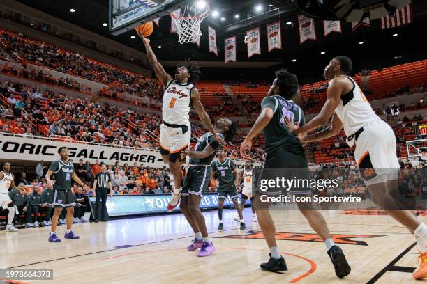 Oklahoma State Cowboys guard Quion Williams shoots the ball around Kansas State Wildcats guard Dai Dai Ames on February 3rd, 2024 at Gallagher-Iba...