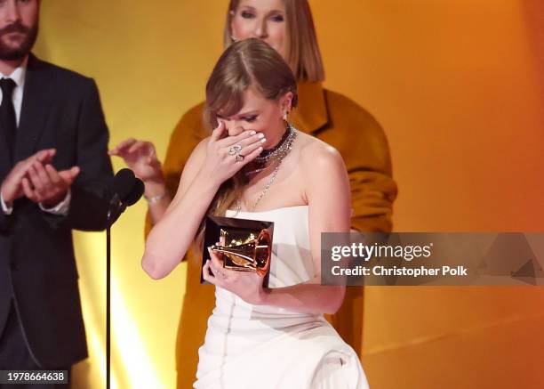 Taylor Swift accepts the Album Of The Year award for "Midnights" on stage with Celine Dion at the 66th Annual GRAMMY Awards held at Crypto.com Arena...