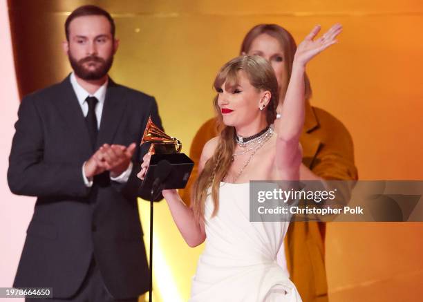 Taylor Swift accepts the Album Of The Year award for "Midnights" on stage with Celine Dion at the 66th Annual GRAMMY Awards held at Crypto.com Arena...