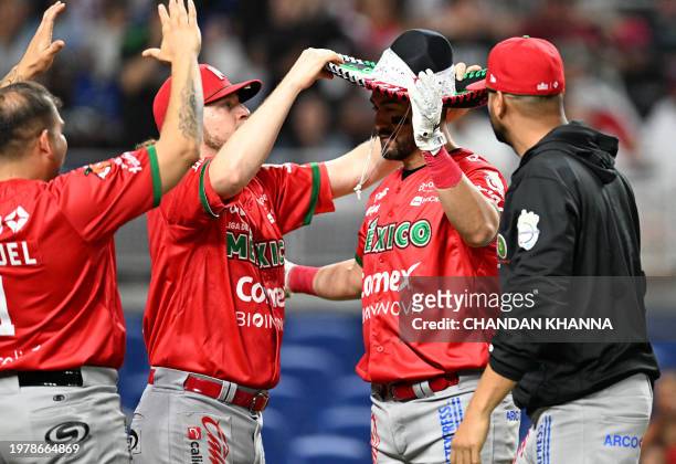Mexico's infielder Agustin Murillo Pineda wears a sombrero as he celebrates with teammates after hitting a homerun during the Caribbean Series...