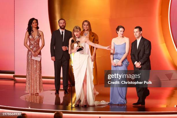 Taylor Swift accepts the Album Of The Year award for "Midnights" on stage with Celine Dion and Jack Antonoff at the 66th Annual GRAMMY Awards held at...