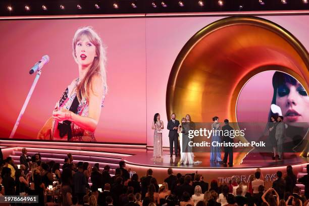 Taylor Swift accepts the Album Of The Year award for "Midnights" on stage with Celine Dion and Lana Del Rey at the 66th Annual GRAMMY Awards held at...