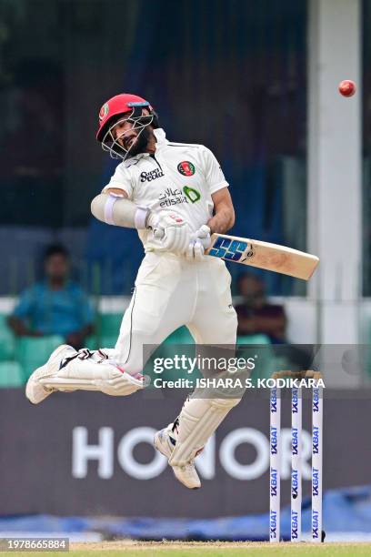 Afghanistan's Ikram Alikhil avoids a bouncer on the fourth day of the one-off Test cricket match between Sri Lanka and Afghanistan at the Sinhalese...