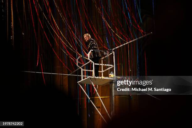 High-wire walker Philippe Petit prepares to walk a high wire through the ribbons of Divine Pathways at the Cathedral of St. John the Divine on...