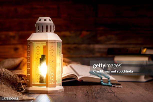 al quran and a beautiful arabian lamp - arabic calligraphy stock pictures, royalty-free photos & images