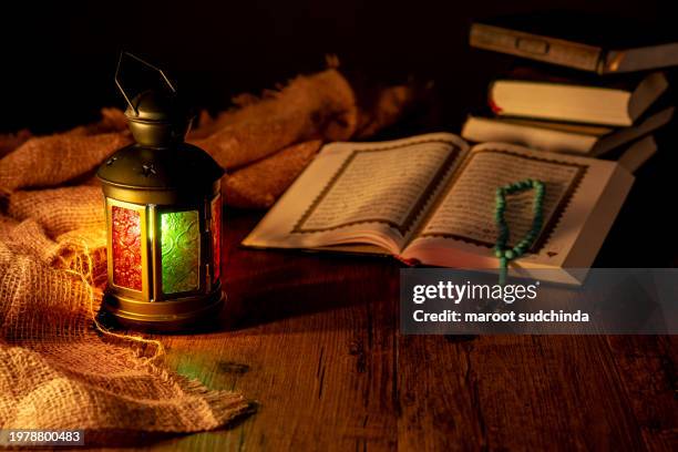 al quran and a beautiful arabian lamp - arabic calligraphy stock pictures, royalty-free photos & images