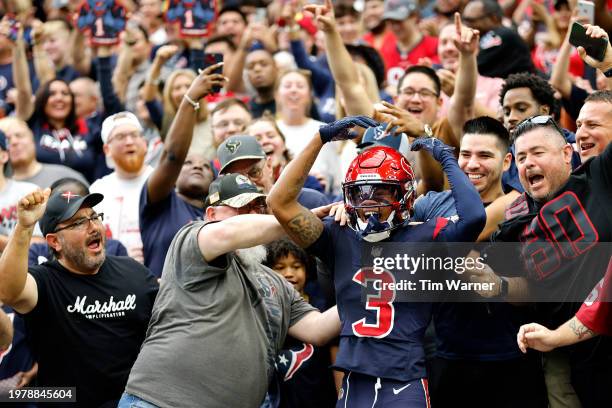 Tank Dell of the Houston Texans climbs into stands after a second quarter touchdown during a game against the Arizona Cardinals at NRG Stadium on...