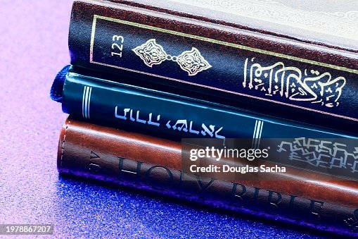 Interfaith symbols - Christianity Bible, Islam Quran and Judaism Old Testament books.