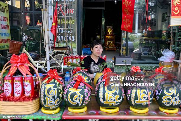 Woman selling decorated watermelons waits for customers in Hanoi on February 5 as Vietnamese prepare to celebrate their traditional Tet or Lunar New...