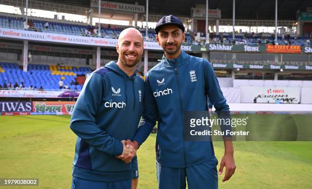 Debutant Shoaib Bashir receives his test cap from Jack Leach prior to day one of the 2nd Test Match between India and England at ACA-VDCA Stadium on...