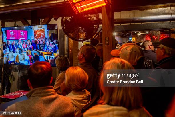 Attendees watch a television monitor from outside a rally being held by Republican presidential candidate, former U.N. Ambassador Nikki Haley at the...