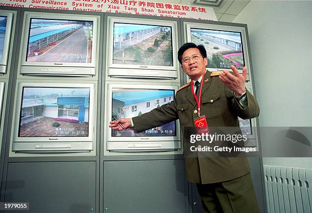 Military officer explains the surveillance system of the newly built 1000 bed SARS hospital to journalists on May 7, 2003 in Xiaotangshan. China is...