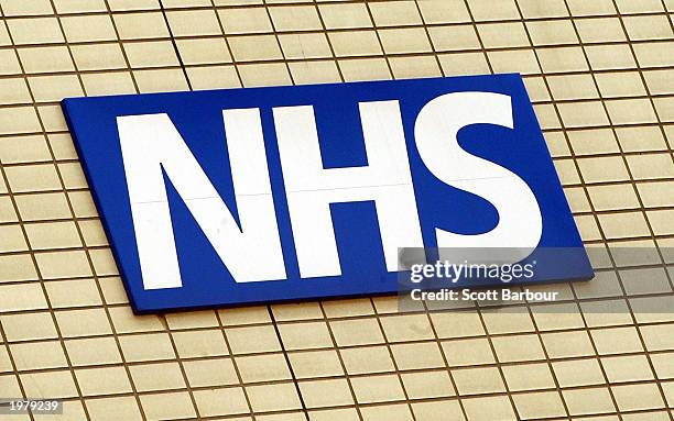 The National Health Service logo is shown on the wall outside St Thomas's Hospital May 7, 2003 in London, England. Britain's Health Secretary Alan...