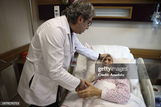 Year-old Hatice Duzer, who was rescued from under the rubble in the earthquakes on Feb. 6 is seen with her doctor before being discharged with a cake...