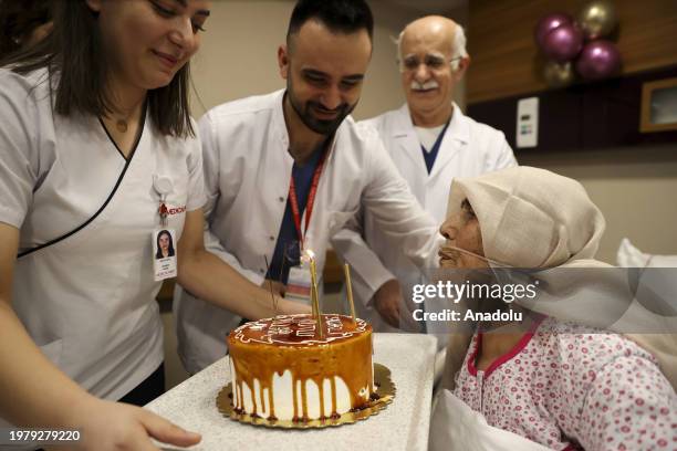 Year-old Hatice Duzer, who was rescued from under the rubble in the earthquakes on Feb. 6 being discharged with a cake after receiving treatment in...