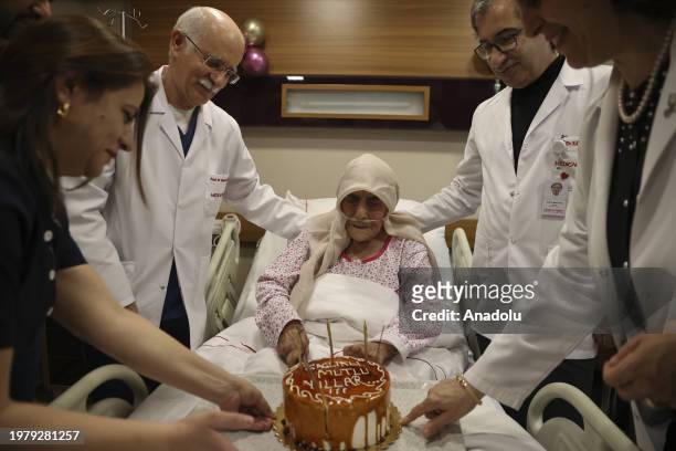 Year-old Hatice Duzer, who was rescued from under the rubble in the earthquakes on Feb. 6 being discharged with a cake after receiving treatment in...
